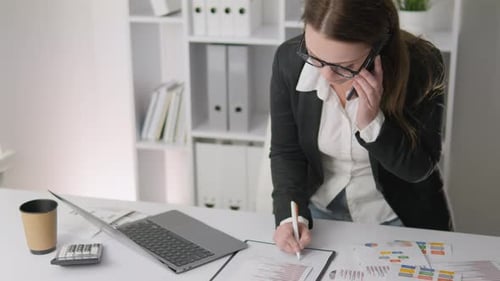 Successful Businesswoman in Finance Office Working Diligently on Project Analysis and Planning