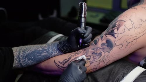 Tattoo Artist Creating Detailed Skull Tattoo