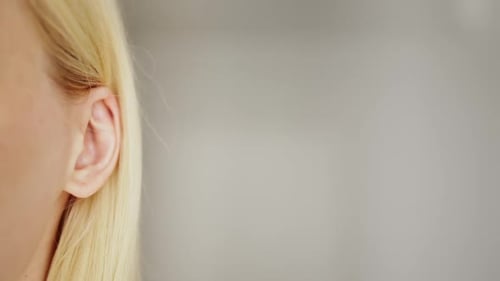 Close-up female ear listening to gossip or news with copy space for text.