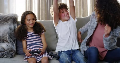 Family, game and fun of kids or siblings playing competitive console video games at home by mother