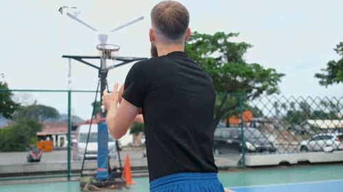 view from the back of a basketball player throws the ball into the basket and hits