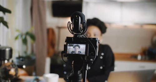 Woman Filming Video with Camera and Microphone at Home