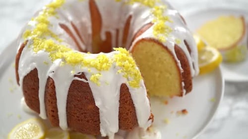 Step By Step Slicing Lemon Bundt Cake Decorated with Lemon Zest on a Cake Stand