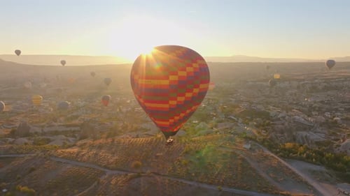 Goreme, Turkey - 01 December 2024: Aerial view of hot air balloons at sunrise, Turkey.