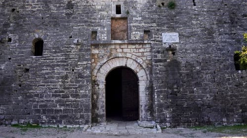 Arched gate of medieval castle with beautiful stone walls, entering inside fortress