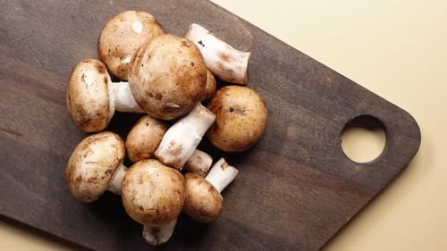 Fresh Cremini Mushrooms on Wooden Cutting Board