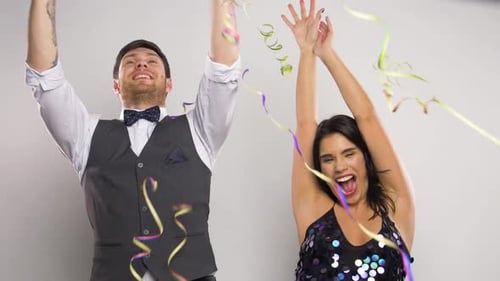 Happy Couple Celebrates with Colorful Confetti and Streamers