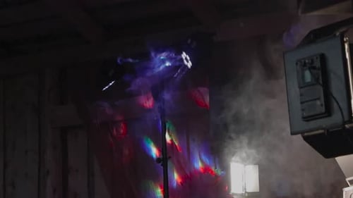 Strobe light or spotlights in the night at a concert or theater on stage. Nightlife has smoke and fo