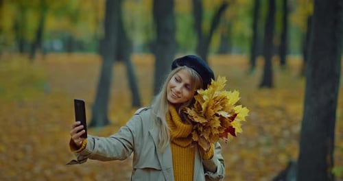 Young Woman Taking Photo of Her Face By Camera of Mobile Phone in Beautiful Autumn Park Prores