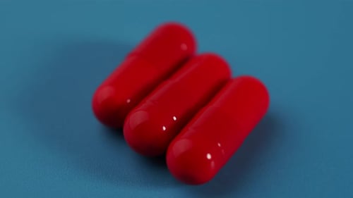 Rote rotierende medizinische Kapseln. Medikamente.