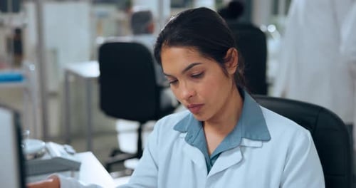 Woman Healthcare Worker Massaging Temples in a Lab