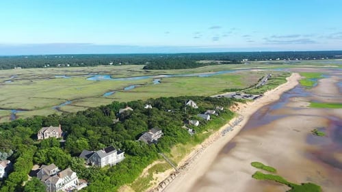 Cape Cod Bay Aerial Drone Footage of Bay Side Beach at Low Tide, Houses, Marsh and People in Ocean