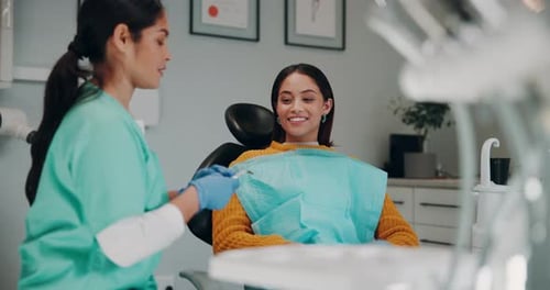 Dentist Performing Checkup on Young Smiling Woman