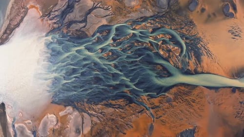 Aerial video over YELLOW RIVER and flowing glaciers in Iceland landscape