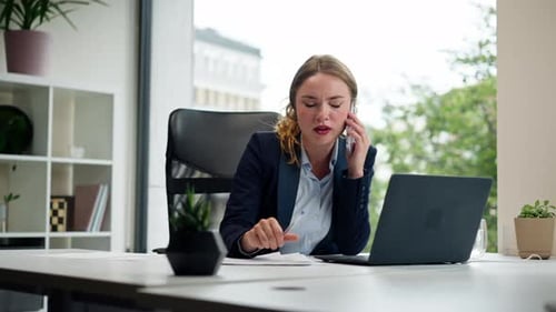 in a Modern Office with a Large Window a Beautiful Worker in a Blue Shirt with a Laptop Young Boss