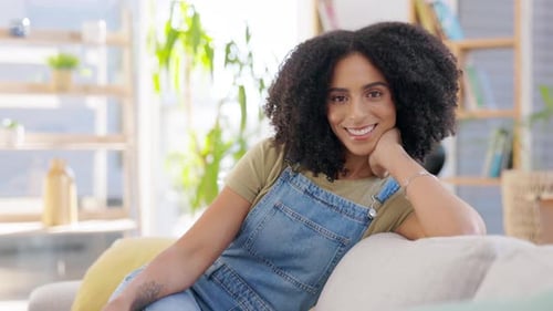 Smiling Woman Relaxing on a Sofa at Home