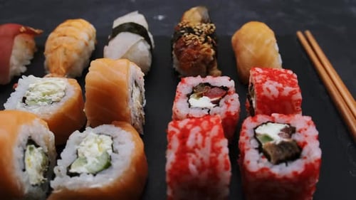 Artful Sushi Rolls Displayed with Golden Chopsticks