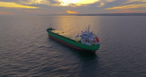 Aerial View of Huge Bulk Carrier Tanker Anchored in Deep Blue Mediterranean Sea at Sunset