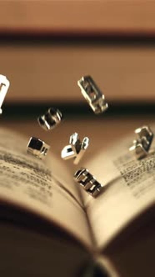 English Letters Fall on an Open Book Filmed is Slow Motion 1000 Frames Per Second