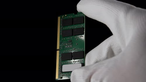 In the Darkness Hand Securely Grasping RAM DDR4 Sodimm for PC