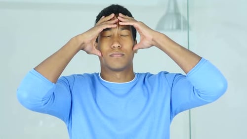 Headache Upset Tense Young AfroAmerican Man Holding His Head