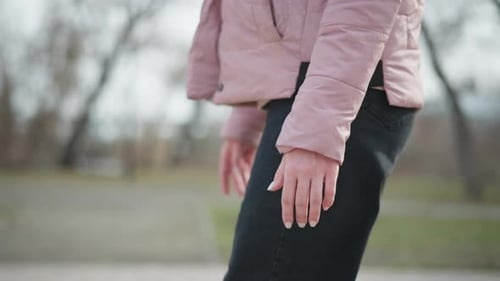 Woman Walking in Park with Pink Jacket
