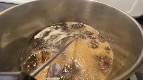 Making maple syrup by boiling maple sap in pot