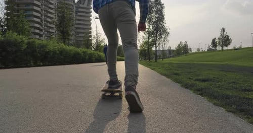 A boy practices skateboarding in the middle of the city, between buildings and skyscrapers. Concep