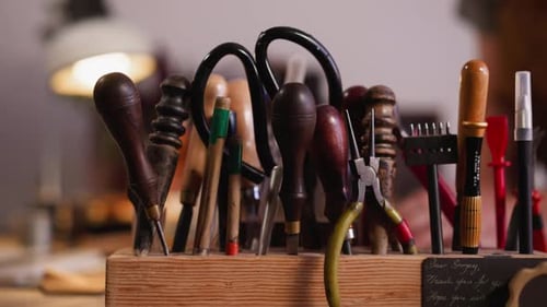 Rack with Kit of Different Leathersmith Tools on Workbench