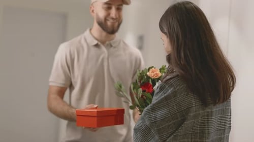 Woman Receives Flowers and Gift from Happy Man