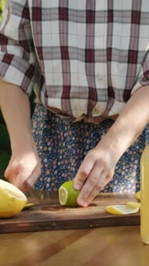 Lime Being Cut on Wooden Cutting Board Outdoors