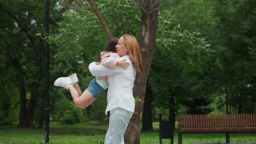 Reunion in Park with Laughter and Hugging Moments Mother and Daughter Joyfully Reunite with