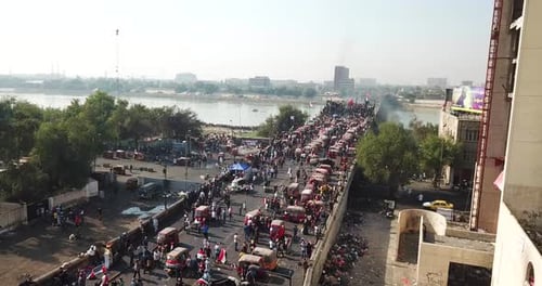 Crowd of People and Vehicles on Bridge