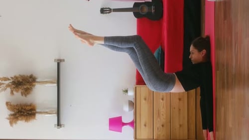 Adult Woman Exercising on a Yoga Mat