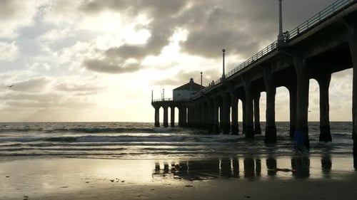 Person at Beach with Pier at Sunset