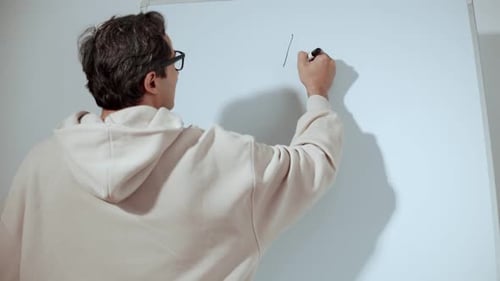 Man Writing Idea and Concept on Whiteboard