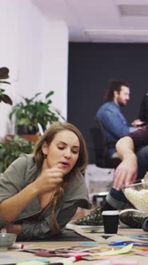 Discussion, meeting or people with popcorn in creative agency, magazine production or layout review