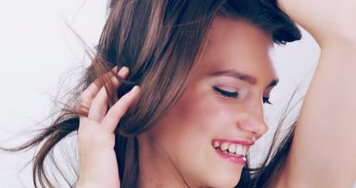 Woman Smiling While Playing With Her Long Hair