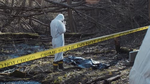 Forensic Specialist Working in the Forest Police Criminalists Collecting Evidence and Making