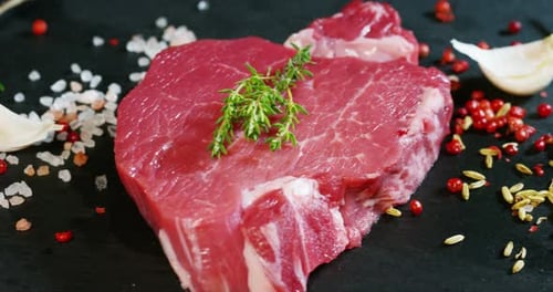 Raw Red Steak Garnished with Thyme and Herbs