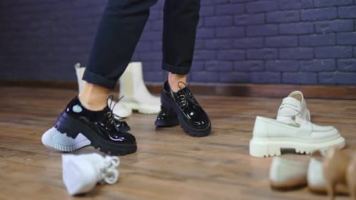 Feet Stand Among Fashionable Shoes