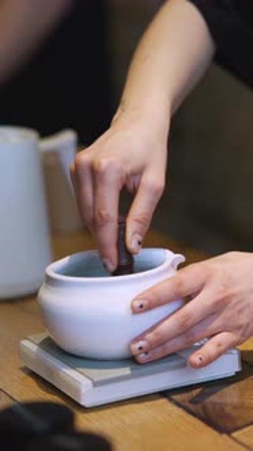 Matcha Process of Making Green Tea in a Bowl on Wooden Table Background