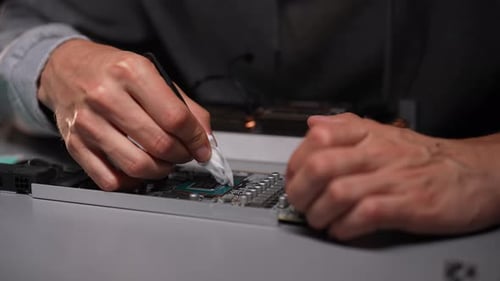Professional Computer Technician Male Cleaning CPU of Desktop Computer Motherboard Using Cleaning