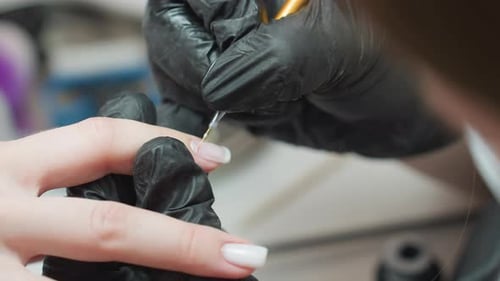 Nail Technician Applying Acrylic with Tiny Brush on Client Fingernail