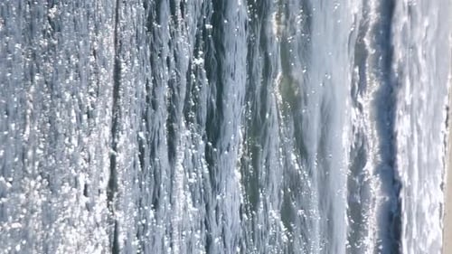 Sea Waves and White Reflections of Sun on Surface of Sea Waves on Sandy Beach