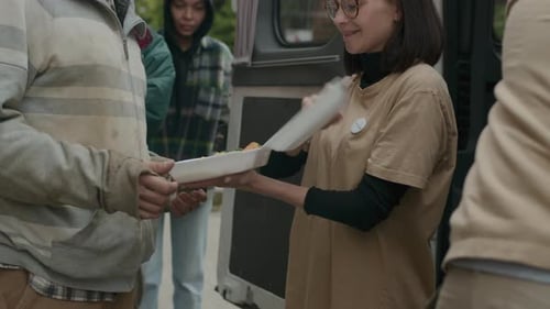 Poor People Taking Free Food from Volunteers