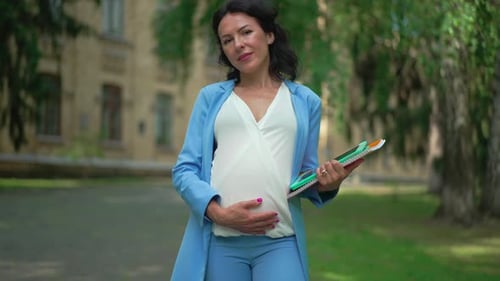 Portrait of Confident Beautiful Pregnant Caucasian Woman Looking at Camera Standing Outdoors with