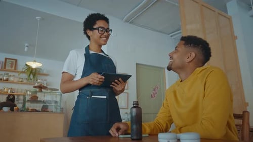 Cinematic image of waiters employees working in a nordic styled cafe