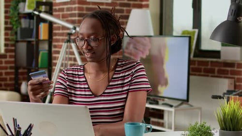 Woman Shops Online with Credit Card and Laptop