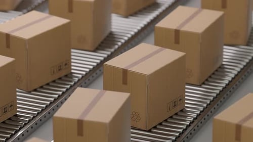 Cardboard boxes moving on a conveyor belt in a warehouse